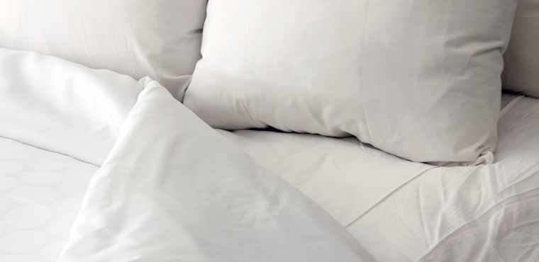 White bed, pillows and duvet