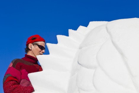 Man making a snow sculpture